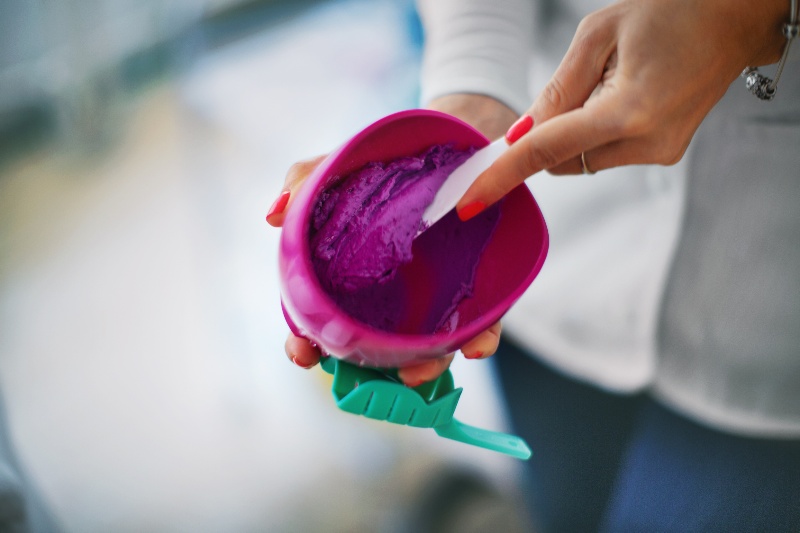 A Person Mixing Dental Alginate Impression Material in a Mixing Bowl